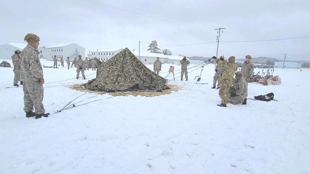 Airmen learn to build Arctic 10-person tents during cold-weather training at Fort McCoy