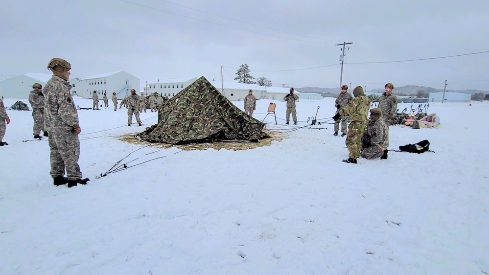 Airmen learn to build Arctic 10-person tents during cold-weather training at Fort McCoy