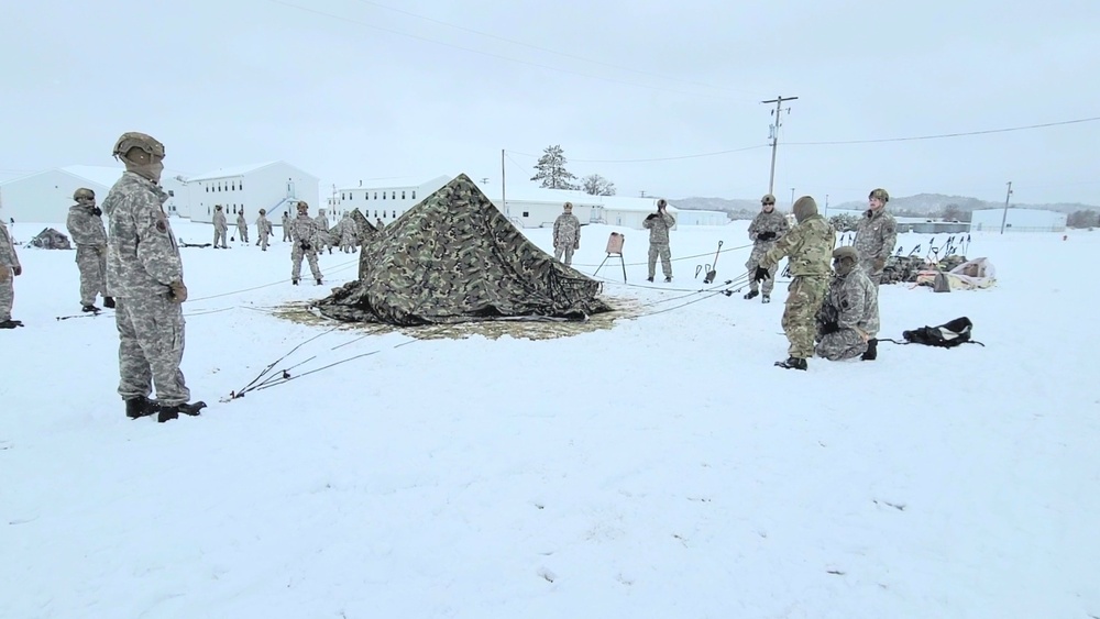 Airmen learn to build Arctic 10-person tents during cold-weather training at Fort McCoy