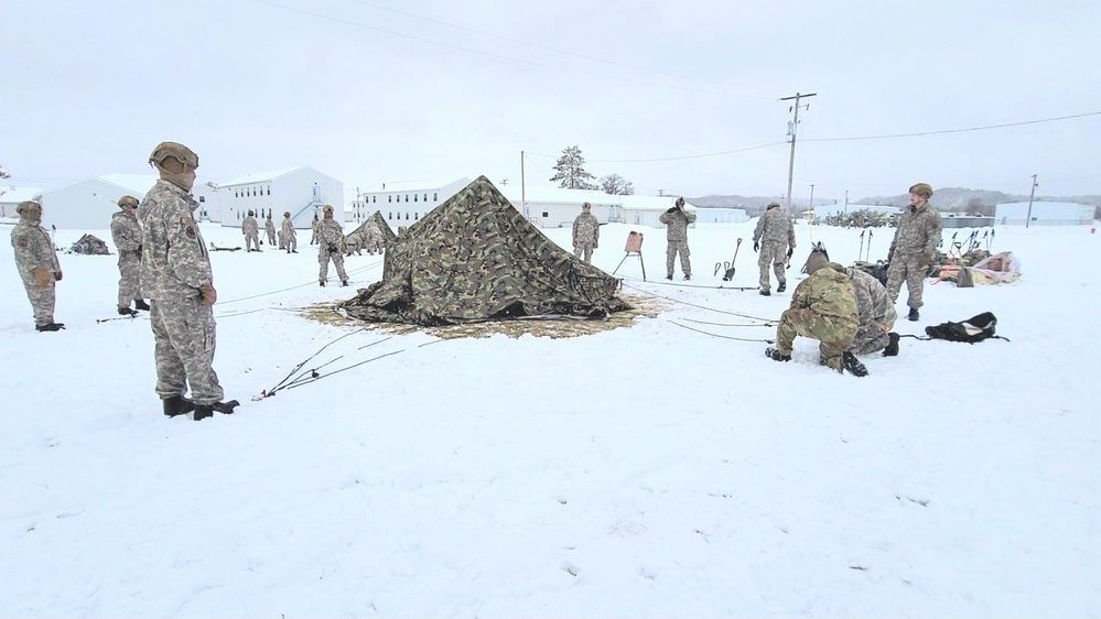 Airmen learn to build Arctic 10-person tents during cold-weather training at Fort McCoy