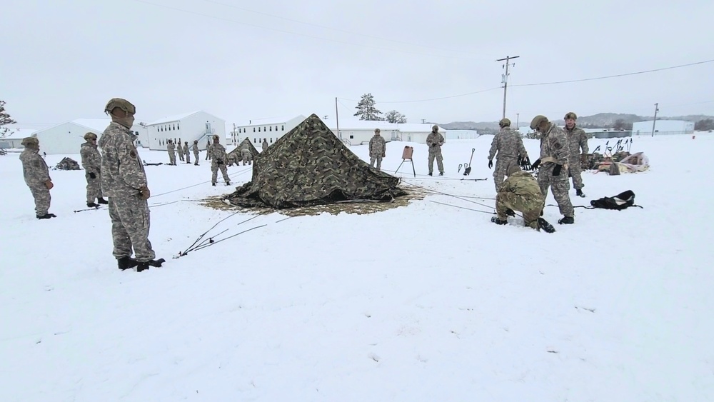 Airmen learn to build Arctic 10-person tents during cold-weather training at Fort McCoy