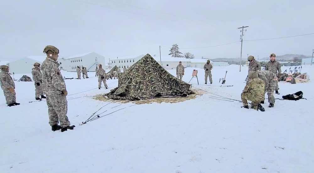 Airmen learn to build Arctic 10-person tents during cold-weather training at Fort McCoy