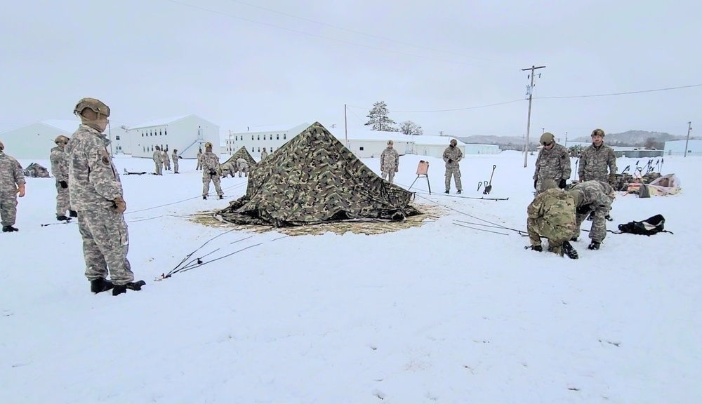 Airmen learn to build Arctic 10-person tents during cold-weather training at Fort McCoy