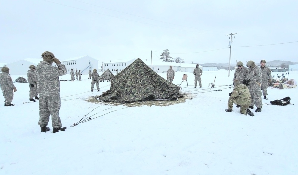 Airmen learn to build Arctic 10-person tents during cold-weather training at Fort McCoy