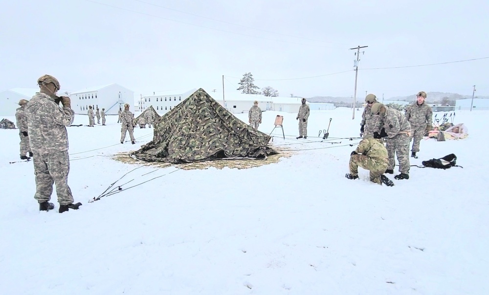 Airmen learn to build Arctic 10-person tents during cold-weather training at Fort McCoy