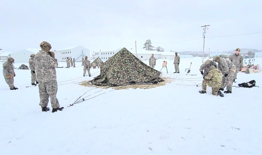 Airmen learn to build Arctic 10-person tents during cold-weather training at Fort McCoy