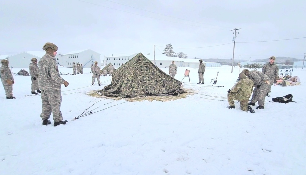 Airmen learn to build Arctic 10-person tents during cold-weather training at Fort McCoy