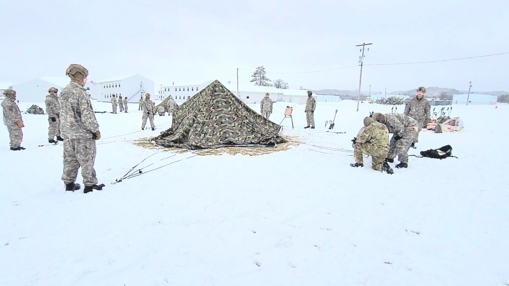 Airmen learn to build Arctic 10-person tents during cold-weather training at Fort McCoy