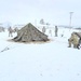 Airmen learn to build Arctic 10-person tents during cold-weather training at Fort McCoy