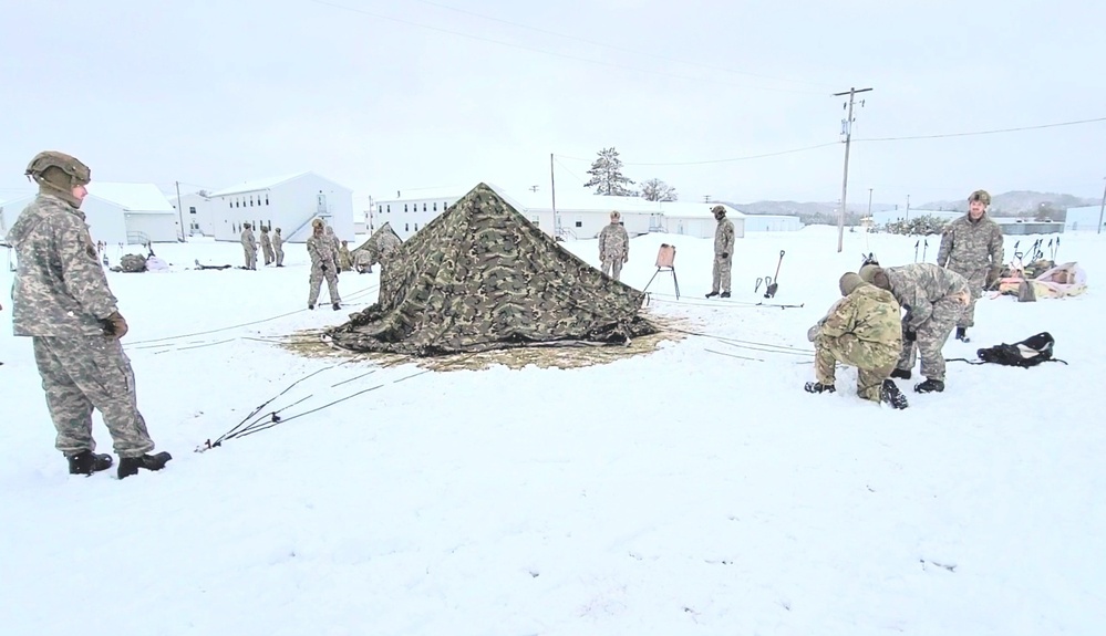 Airmen learn to build Arctic 10-person tents during cold-weather training at Fort McCoy