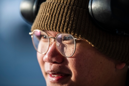 A close up photo of a man wearing a hat and glasses.