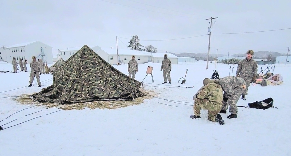 Airmen learn to build Arctic 10-person tents during cold-weather training at Fort McCoy