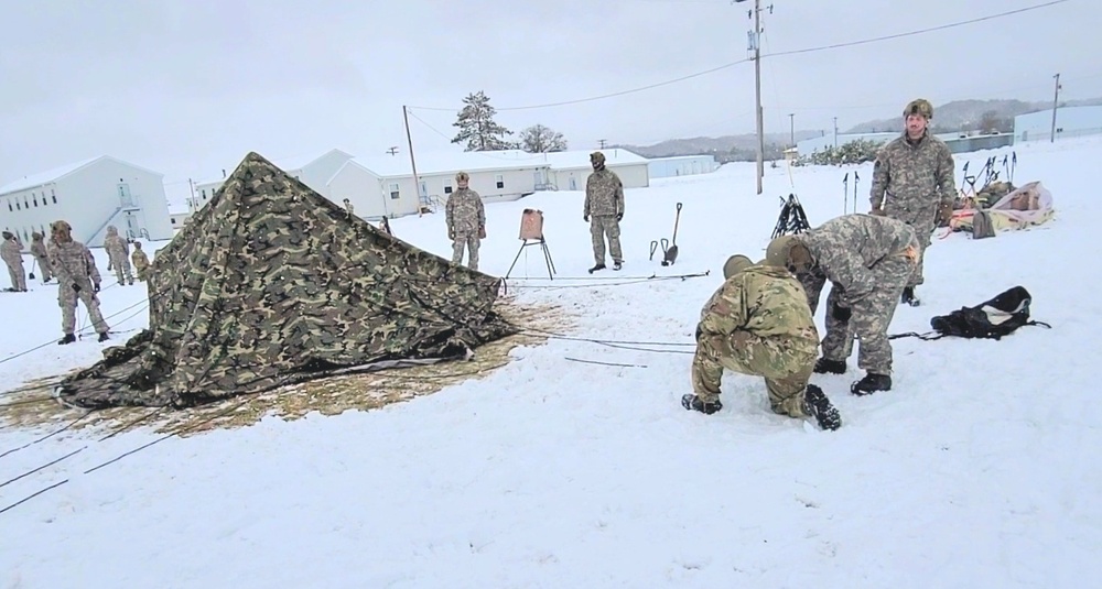 Airmen learn to build Arctic 10-person tents during cold-weather training at Fort McCoy