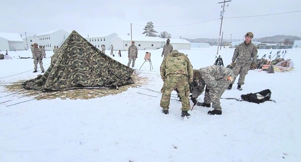 Airmen learn to build Arctic 10-person tents during cold-weather training at Fort McCoy