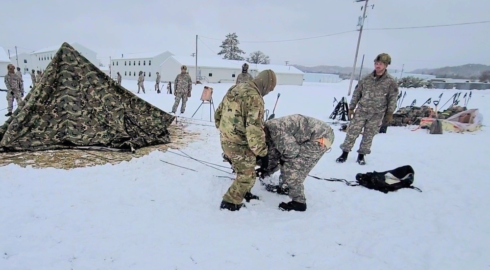 Airmen learn to build Arctic 10-person tents during cold-weather training at Fort McCoy