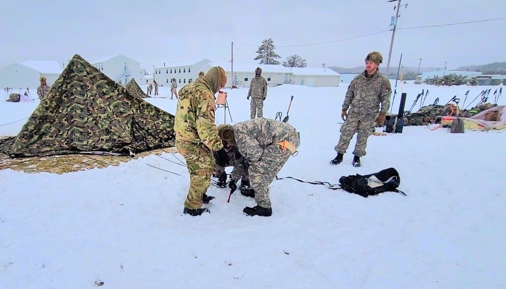 Airmen learn to build Arctic 10-person tents during cold-weather training at Fort McCoy