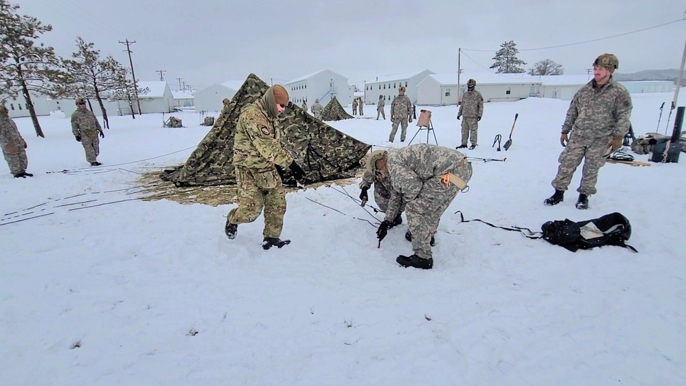 Airmen learn to build Arctic 10-person tents during cold-weather training at Fort McCoy