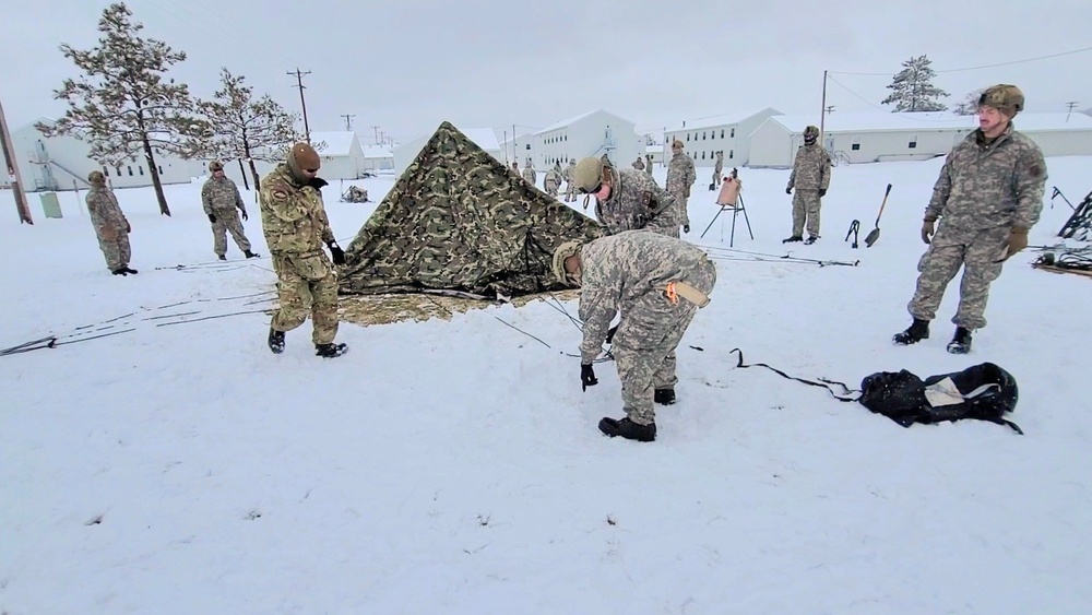 Airmen learn to build Arctic 10-person tents during cold-weather training at Fort McCoy