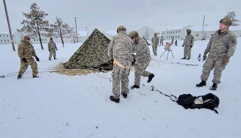 Airmen learn to build Arctic 10-person tents during cold-weather training at Fort McCoy