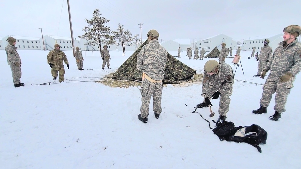 Airmen learn to build Arctic 10-person tents during cold-weather training at Fort McCoy