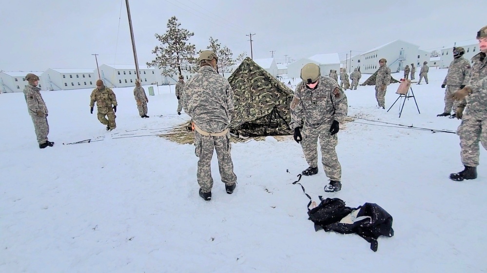 Airmen learn to build Arctic 10-person tents during cold-weather training at Fort McCoy