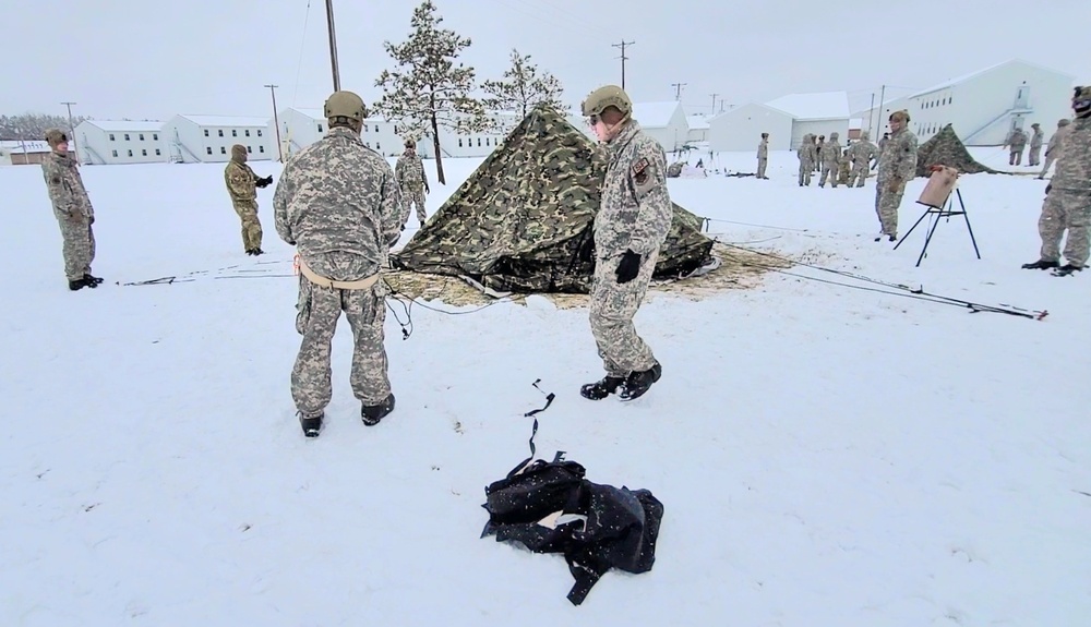 Airmen learn to build Arctic 10-person tents during cold-weather training at Fort McCoy