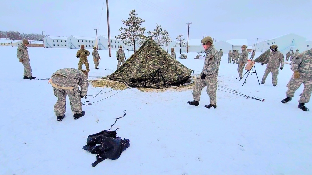 Airmen learn to build Arctic 10-person tents during cold-weather training at Fort McCoy