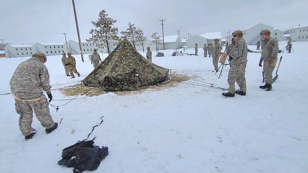 Airmen learn to build Arctic 10-person tents during cold-weather training at Fort McCoy