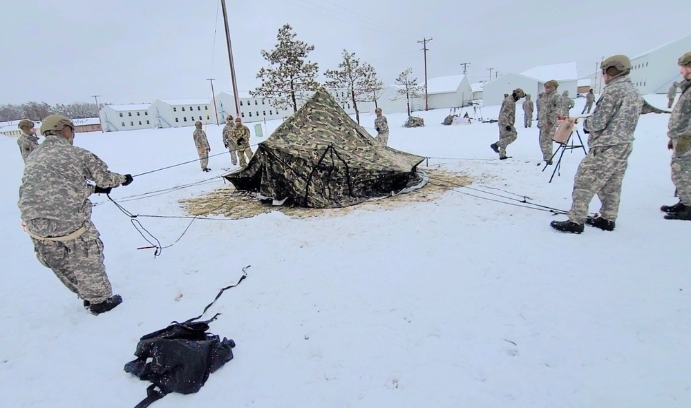 Airmen learn to build Arctic 10-person tents during cold-weather training at Fort McCoy