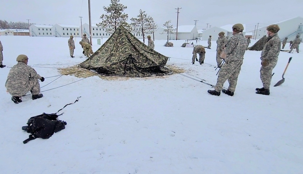 Airmen learn to build Arctic 10-person tents during cold-weather training at Fort McCoy