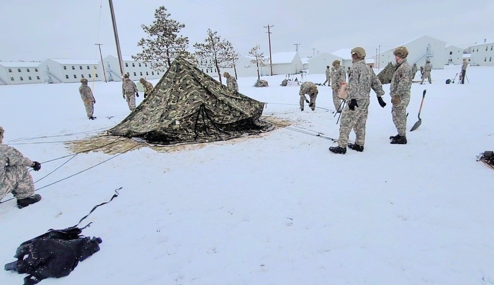 Airmen learn to build Arctic 10-person tents during cold-weather training at Fort McCoy