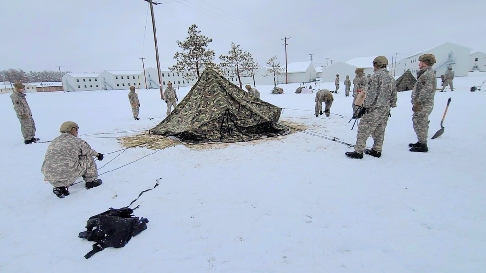 Airmen learn to build Arctic 10-person tents during cold-weather training at Fort McCoy