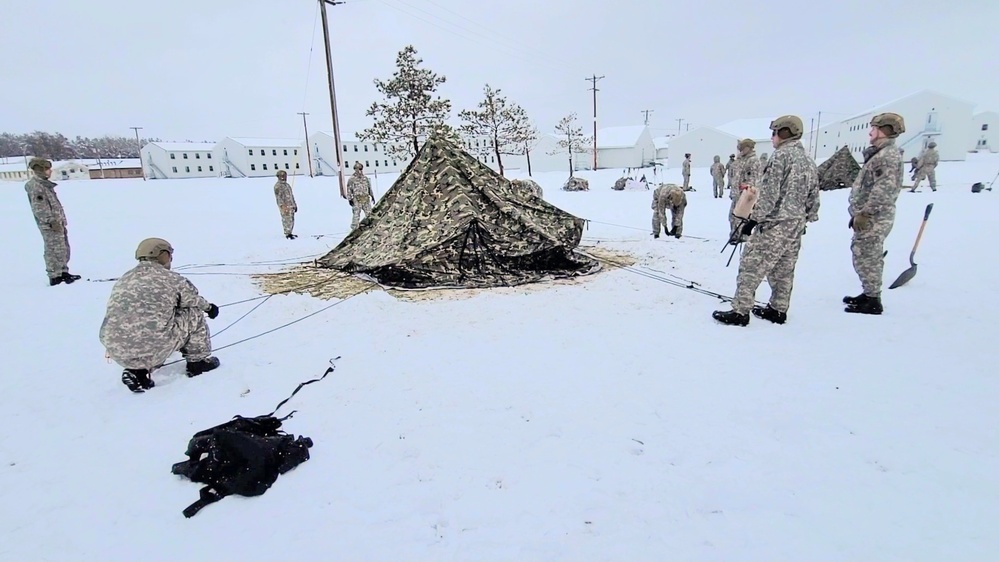 Airmen learn to build Arctic 10-person tents during cold-weather training at Fort McCoy