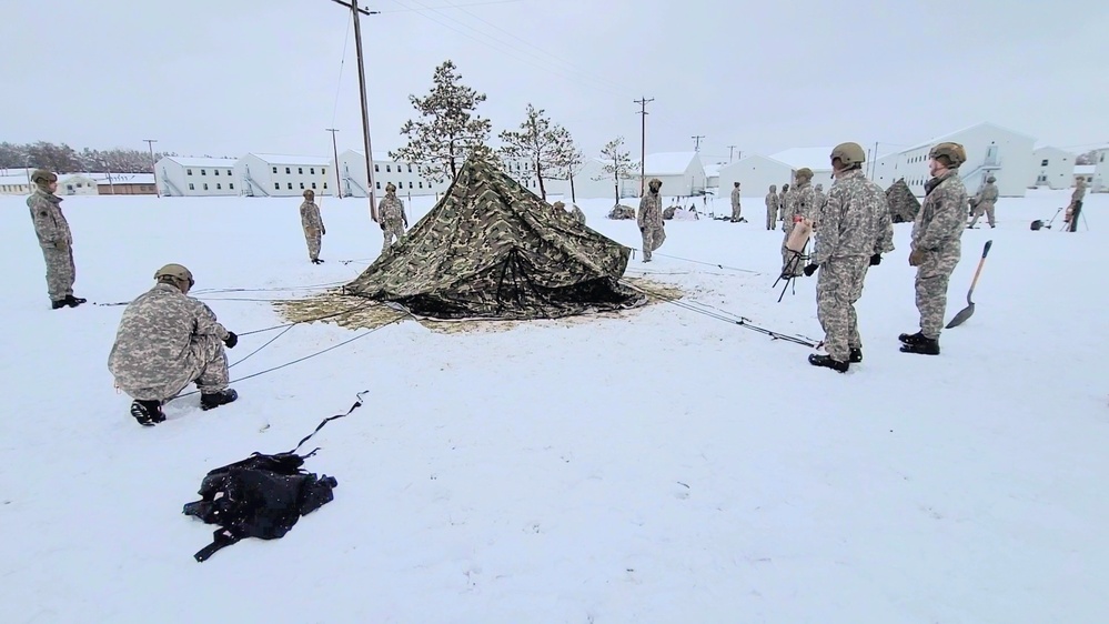 Airmen learn to build Arctic 10-person tents during cold-weather training at Fort McCoy