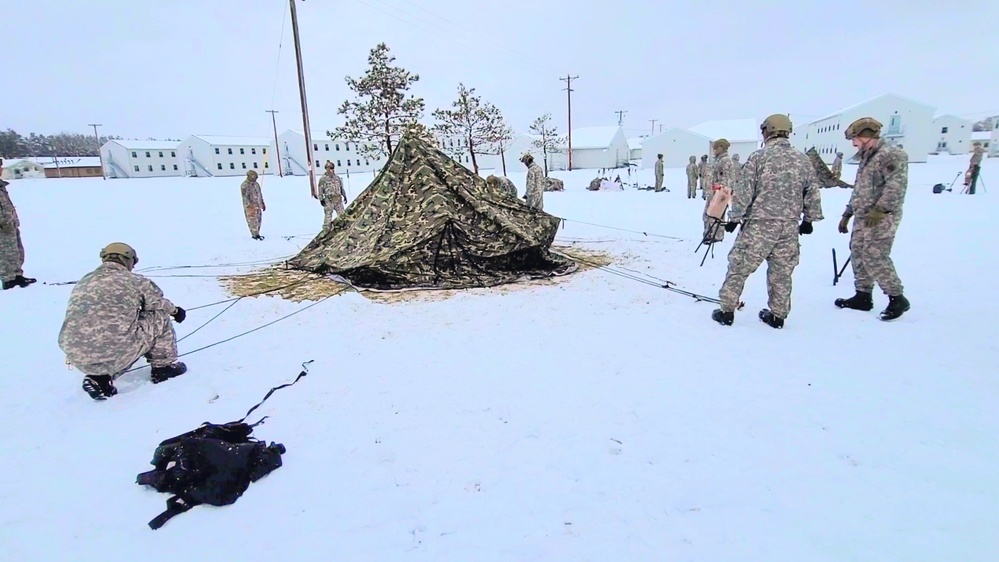 Airmen learn to build Arctic 10-person tents during cold-weather training at Fort McCoy