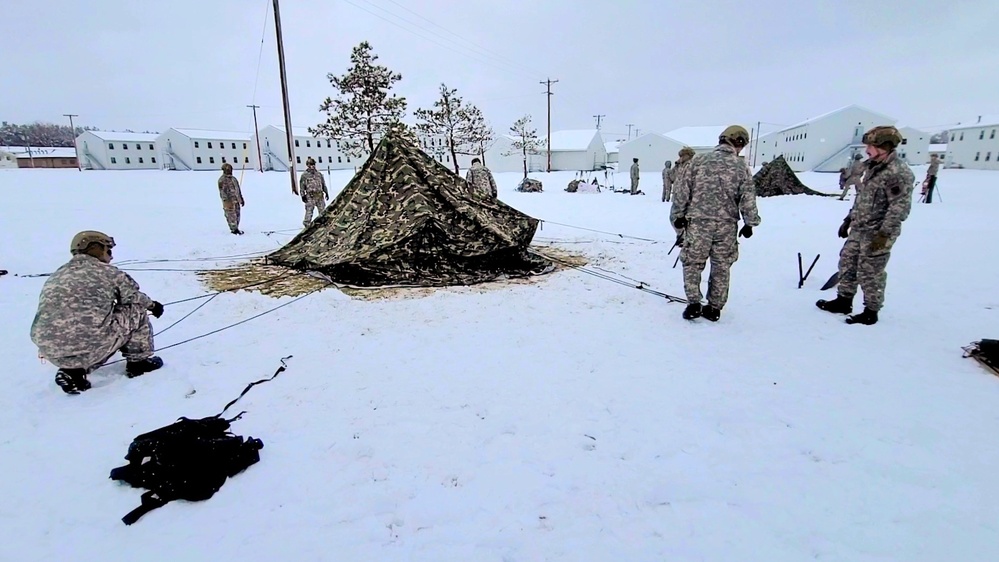 Airmen learn to build Arctic 10-person tents during cold-weather training at Fort McCoy