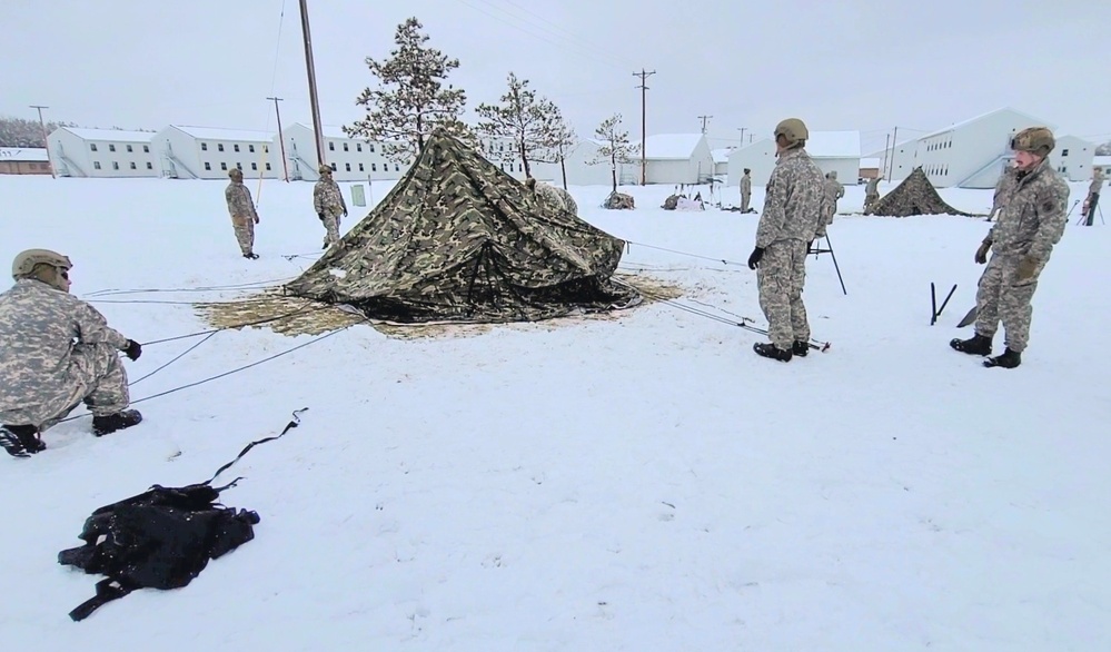 Airmen learn to build Arctic 10-person tents during cold-weather training at Fort McCoy