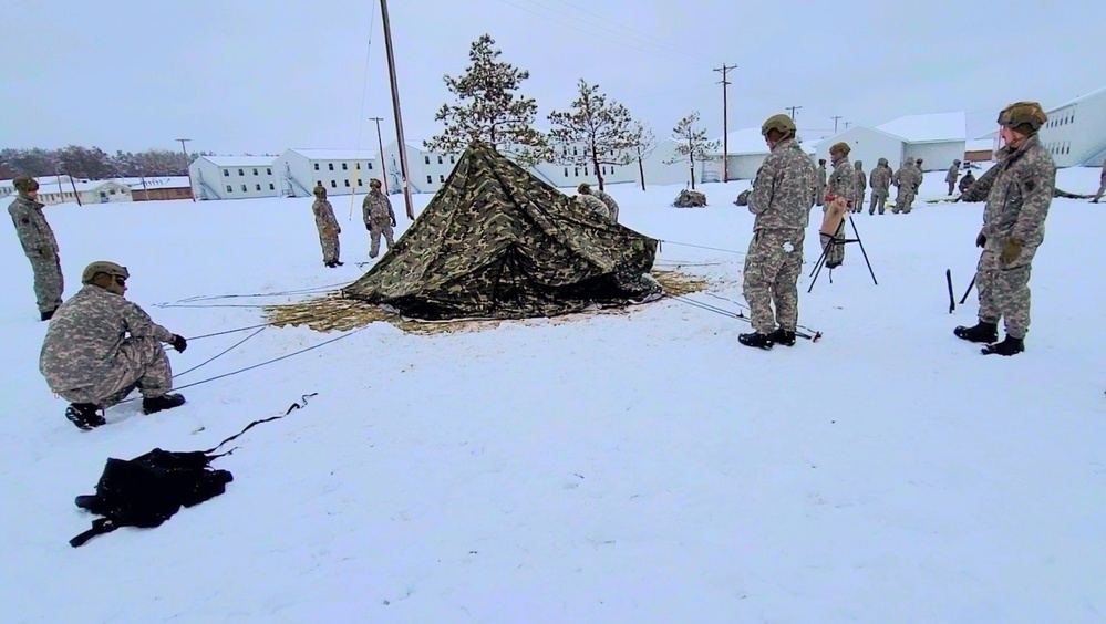 Airmen learn to build Arctic 10-person tents during cold-weather training at Fort McCoy