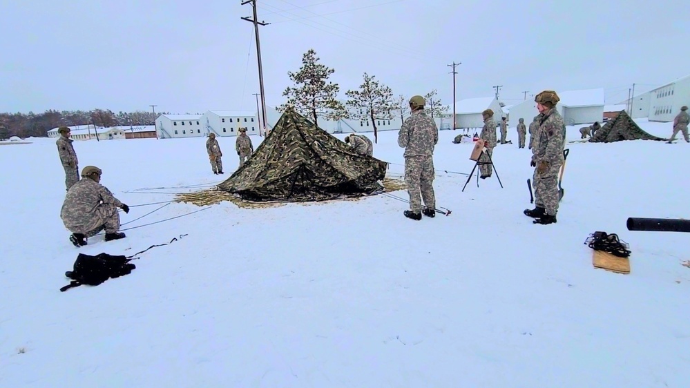 Airmen learn to build Arctic 10-person tents during cold-weather training at Fort McCoy