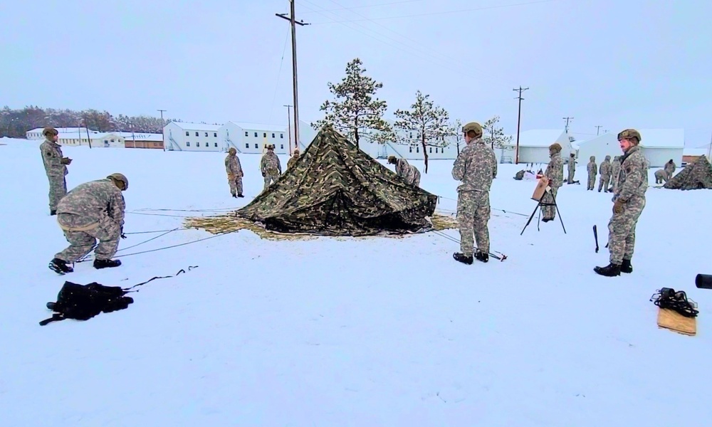 Airmen learn to build Arctic 10-person tents during cold-weather training at Fort McCoy