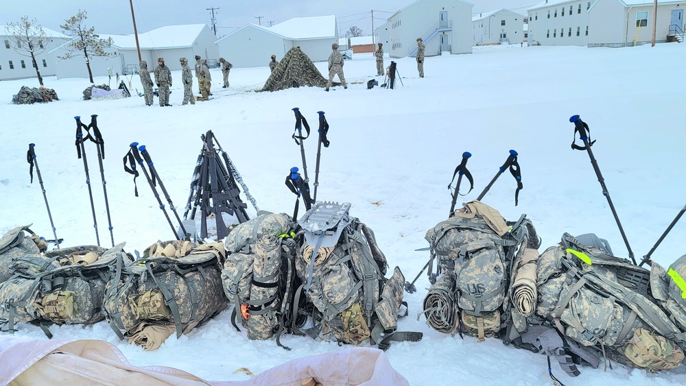 Airmen learn to build Arctic 10-person tents during cold-weather training at Fort McCoy