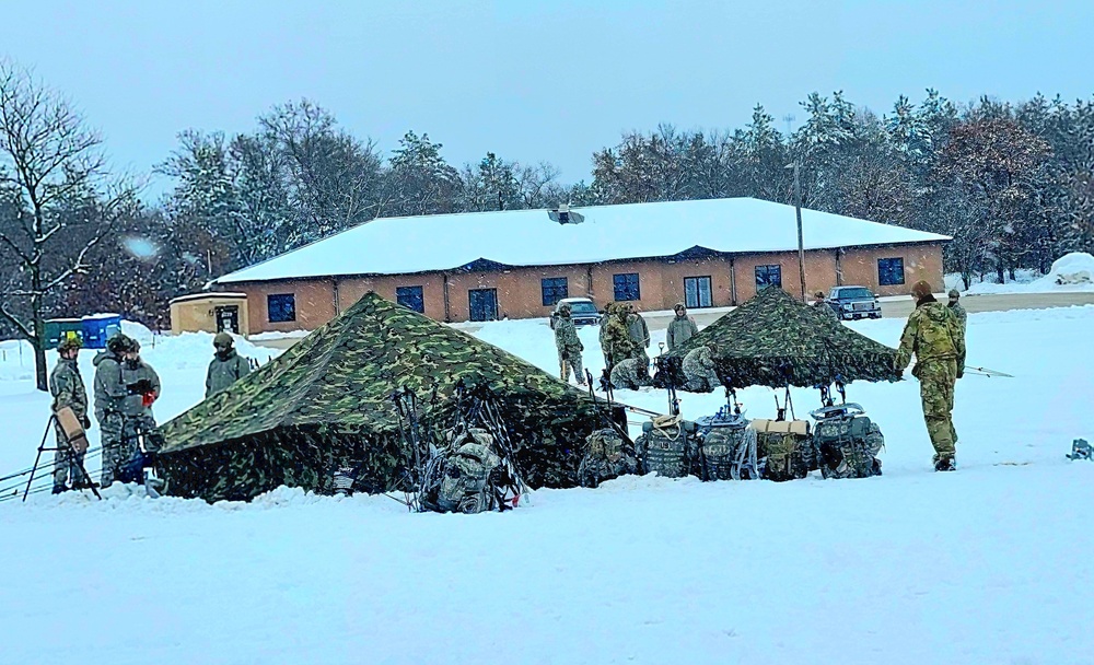 Airmen learn to build Arctic 10-person tents during cold-weather training at Fort McCoy