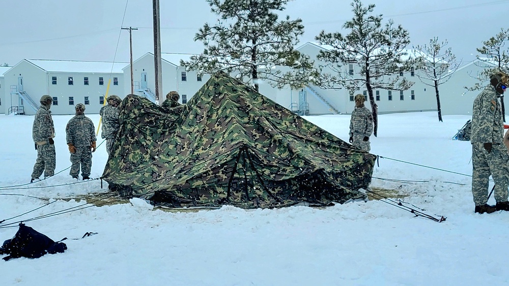 Airmen learn to build Arctic 10-person tents during cold-weather training at Fort McCoy