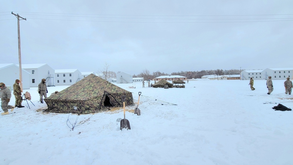 Airmen learn to build Arctic 10-person tents during cold-weather training at Fort McCoy