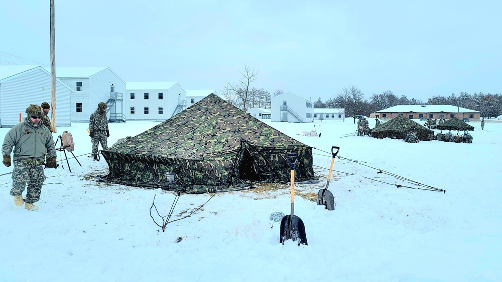 Airmen learn to build Arctic 10-person tents during cold-weather training at Fort McCoy