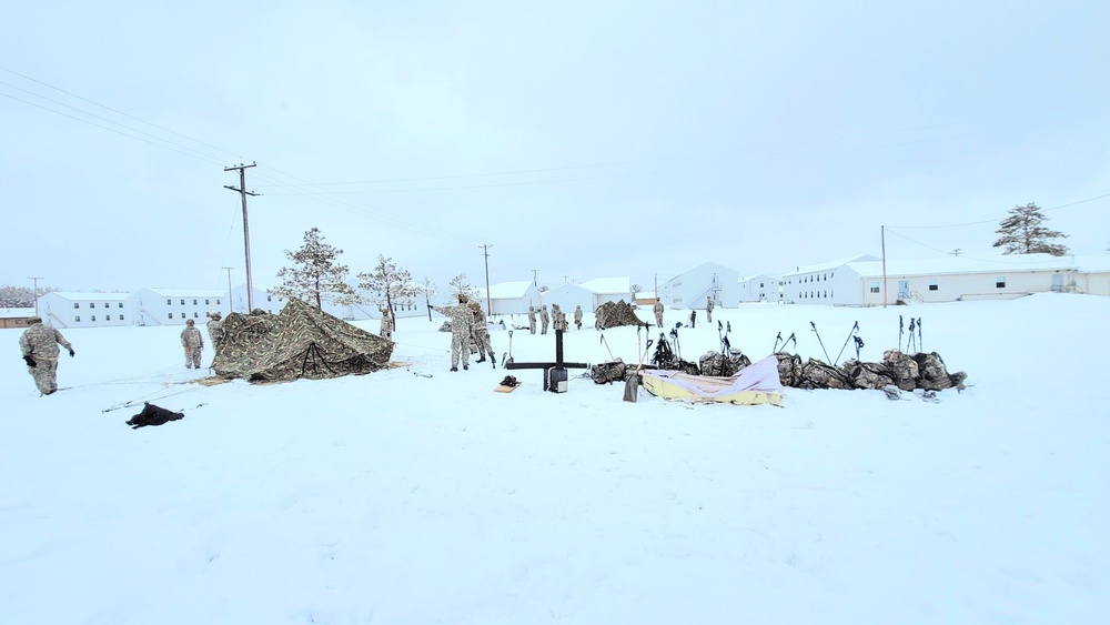 Airmen learn to build Arctic 10-person tents during cold-weather training at Fort McCoy