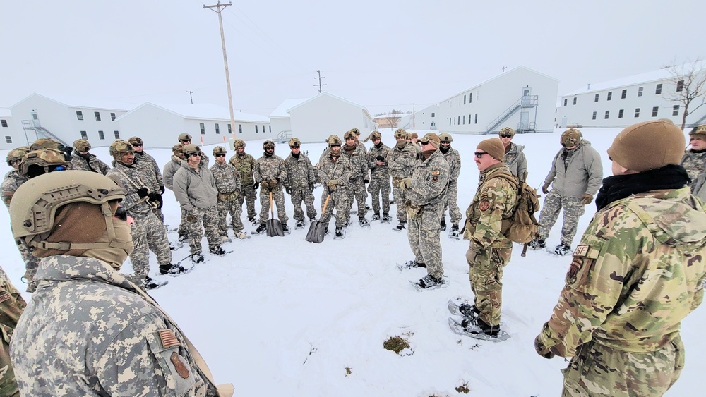 Airmen learn to build Arctic 10-person tents during cold-weather training at Fort McCoy