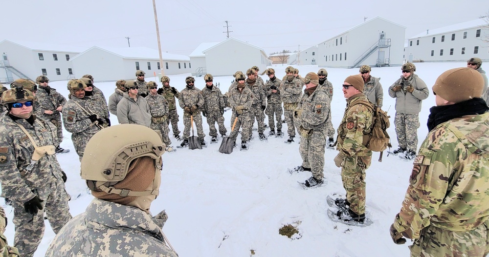 Airmen learn to build Arctic 10-person tents during cold-weather training at Fort McCoy