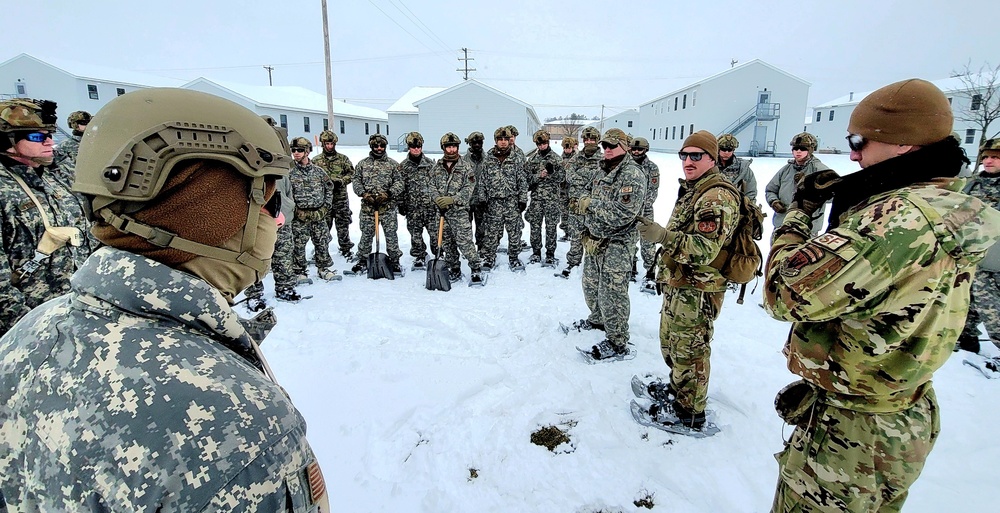 Airmen learn to build Arctic 10-person tents during cold-weather training at Fort McCoy