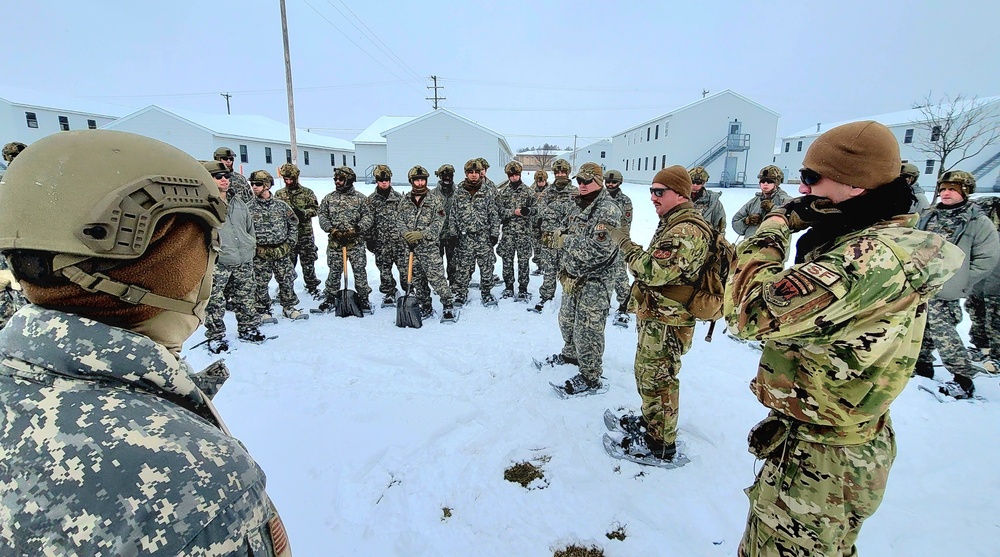 Airmen learn to build Arctic 10-person tents during cold-weather training at Fort McCoy